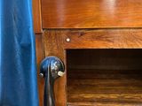 a wooden cabinet with a telephone on the top of it