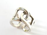 silver ring with two intertwined hearts on a white background