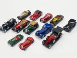 several toy cars are lined up in a row on a white surface