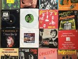 many different types of vinyl records on the wall