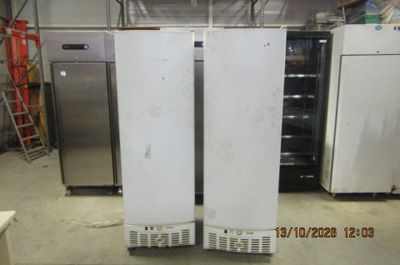 two refrigerators that are sitting in a room