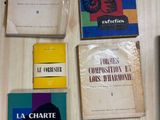 several books are sitting on a table next to each other