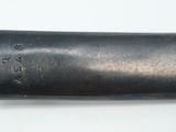 a black pipe that is on a white surface