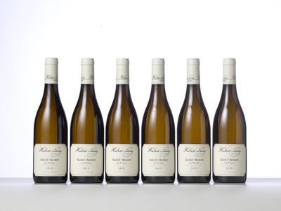 six bottles of white wine lined up in a row