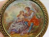 a miniature picture of a man and a woman sitting on a bench