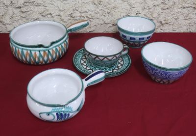 five cups and saucers on a red table cloth