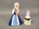 two figurines of a woman and a man on a boat