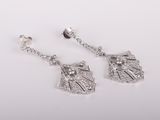 a pair of diamond earrings on a white background