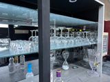 many empty wine glasses sitting on the bar counter