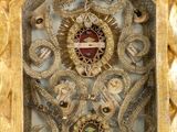 an image of a gold clock with a red and white clock face