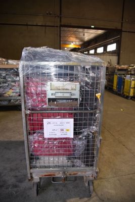 a metal cart with a sign on it in a warehouse