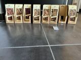 four boxes of granola sitting on a kitchen floor next to a counter