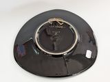 a black plate with a gold ring on top of it