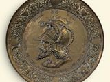 a gold plate with a picture of a man on a horse on it