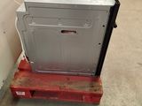 a refrigerator sitting on a pallet in a warehouse