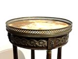 a small table with a marble top on a white background