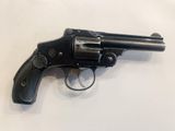 a close up of a revolver on a white surface