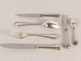 five forks, a knife, and a spoon on a table