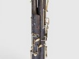 a close up of a clarinet on a white surface with a white background