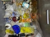 a picture of a trash can filled with perfume and other items