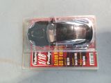 a toy car in a plastic package on a table