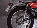 a red motorcycle that is parked in a garage