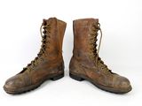 pair of brown leather boots with laces on them on a white background