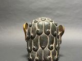 a close up of a vase on a gray surface