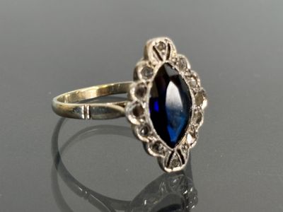 an image of a ring with a blue stone in it