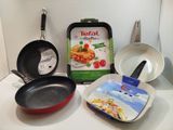 several pans and pans are sitting on a counter with a packet of tefal