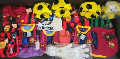 a lot of soccer jerseys and gloves on the couch