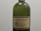 une vieille bouteille d'alcool posée sur une table noire