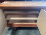 an image of a wooden cabinet with shelves and drawers
