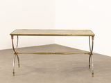 a brass and glass coffee table on a concrete floor