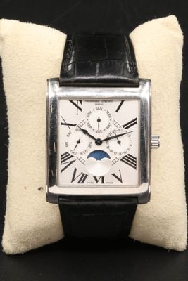 a close up of a wrist watch with a pillow