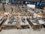many pieces of metal on pallets in a warehouse
