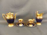 three pieces of blue and gold on the table