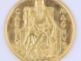 a gold coin with a picture of a man sitting on a throne