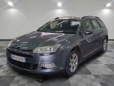 a picture of a grey car parked in a garage