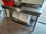 a table with two bins on it in a kitchen