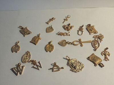 a lot of gold charms on a white surface