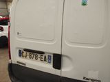 a white van parked in a garage with other cars in the background