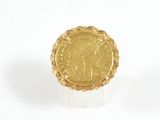 an image of a gold ring with a roman coin in the center