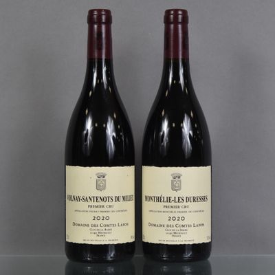 two bottles of wine sitting on top of a table next to each other