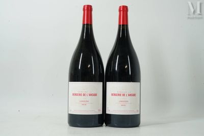 two bottles of red wine sitting next to each other on a table
