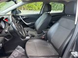 the interior of a car with black leather seats and a black steering wheel
