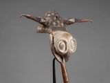 a close up of a sculpture of a bird on a stand