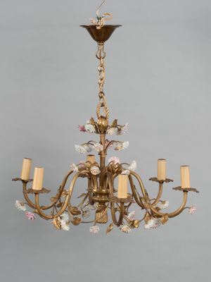 an image of a chandelier with flowers and candles hanging from the ceiling
