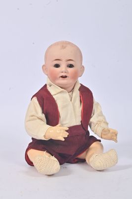a small doll that is sitting on the ground
