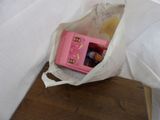 a pink microwave sitting in a plastic bag on the floor